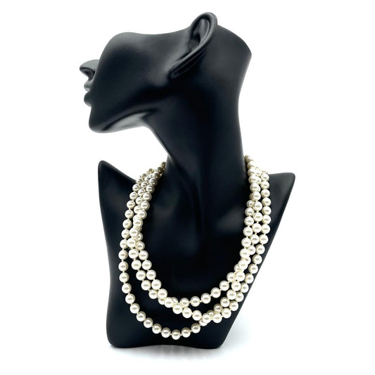 Vintage faux pearl choker necklace, multi-strand design with white pearls and gold clasp, displayed on a black bust.