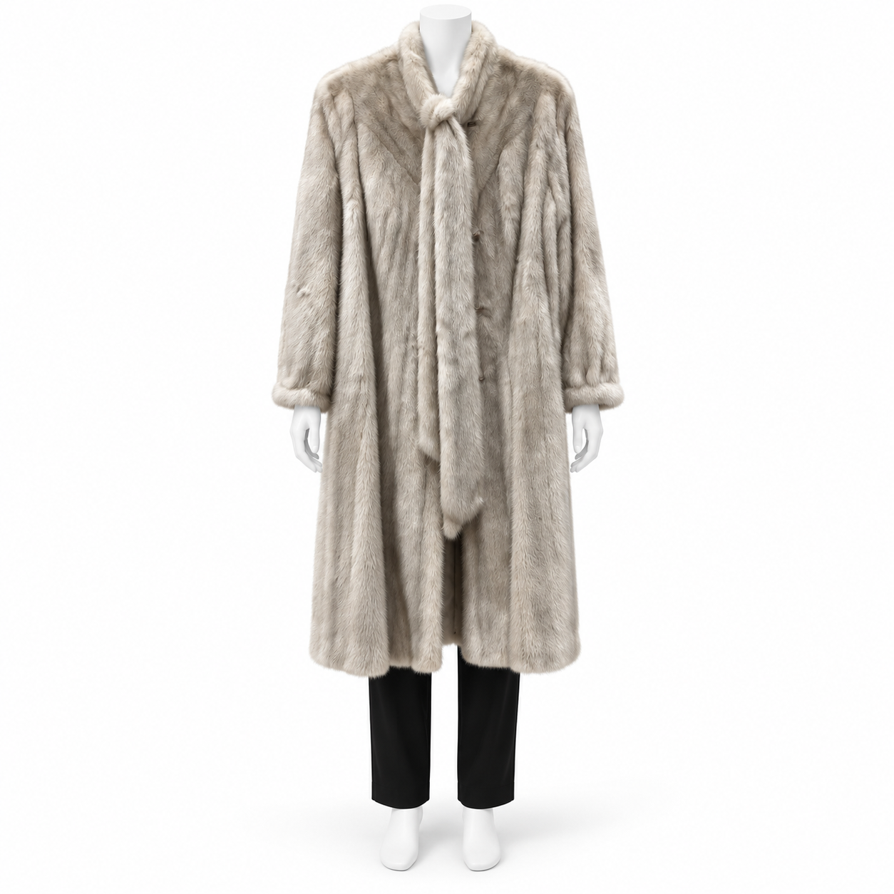 Vintage long cream mink fur coat with a plush shawl collar and chevron back detailing on a mannequin.