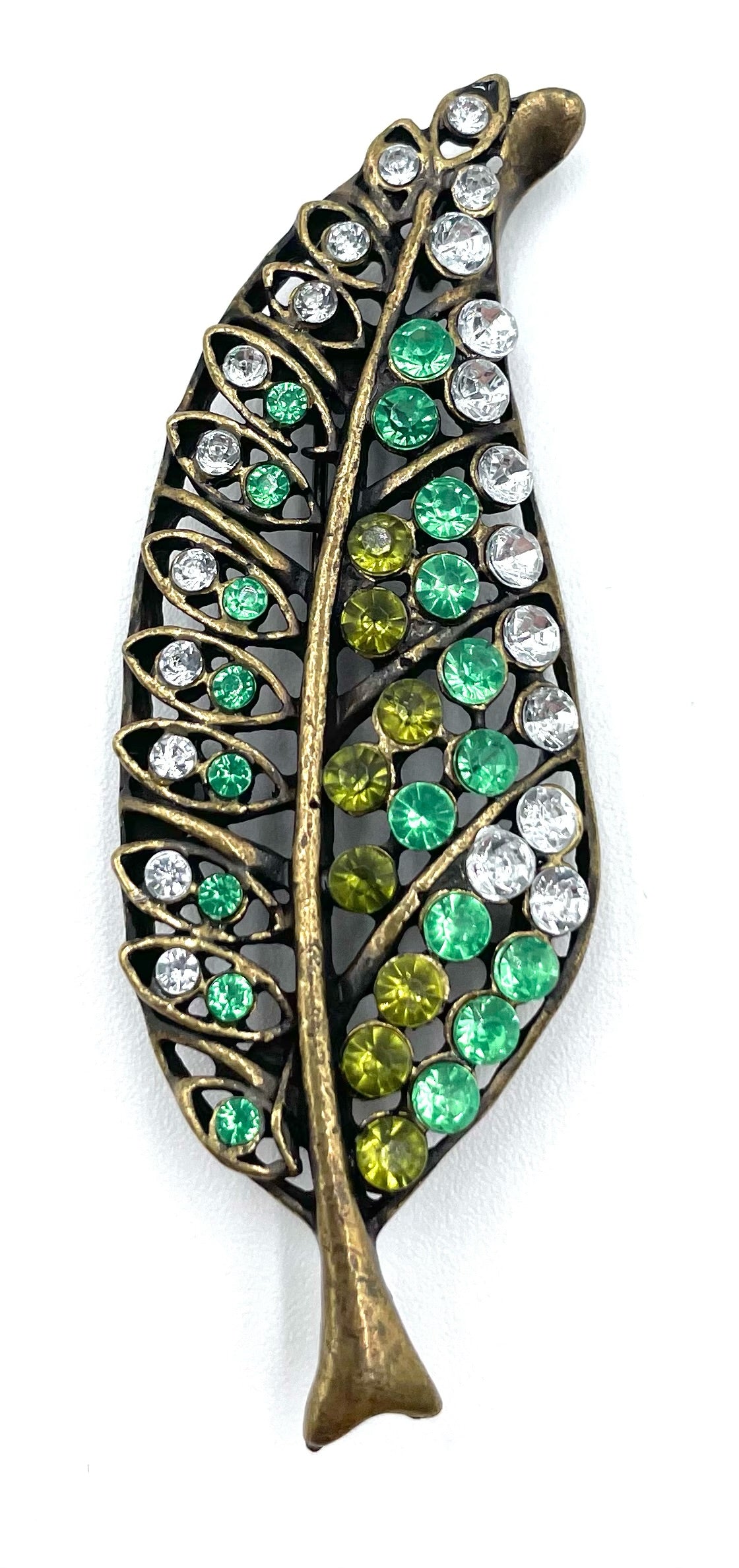 Vintage green and clear rhinestone leaf brooch with antique gold-tone finish.