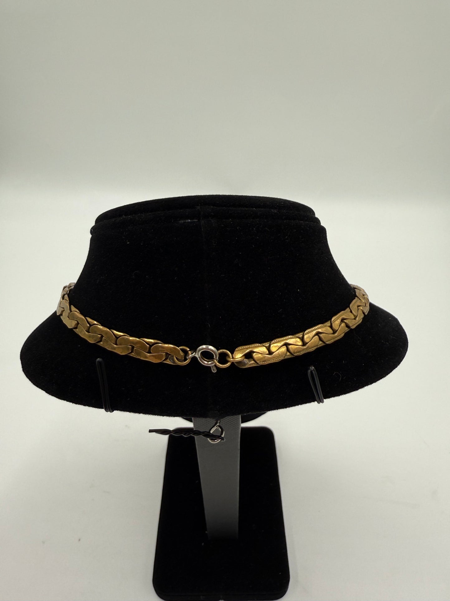 Vintage gold plated bib necklace with a flat chain and clasp, displayed on a black velvet bust.