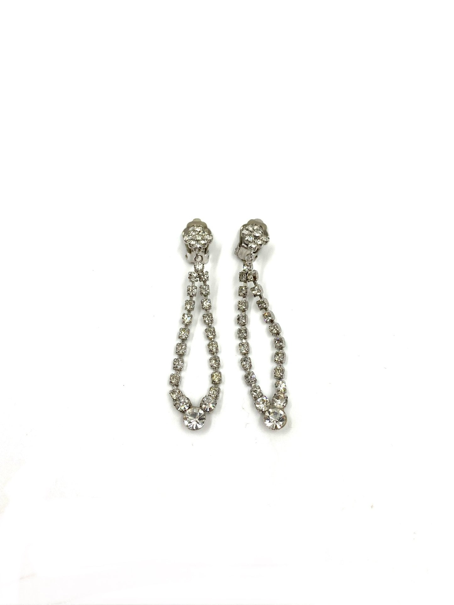 Vintage silver-tone rhinestone drop earrings, 2.5" long, featuring a sparkling looped design.