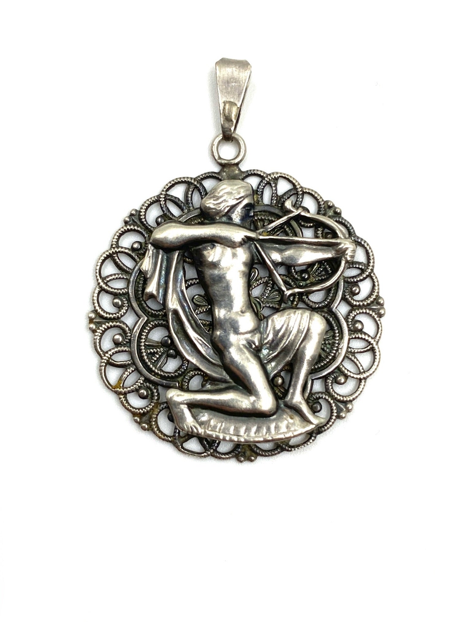 Vintage sterling silver Sagittarius pendant, 1.0” wide, featuring an archer within a filigree circle.