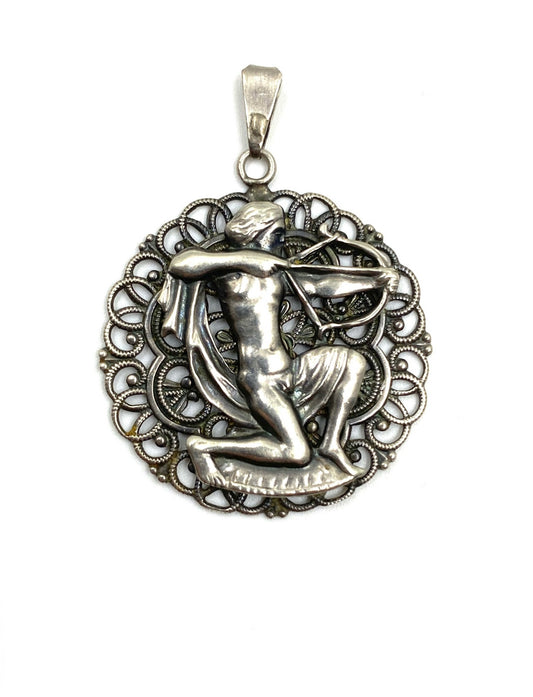 Vintage sterling silver Sagittarius pendant, 1.0” wide, featuring an archer within a filigree circle.